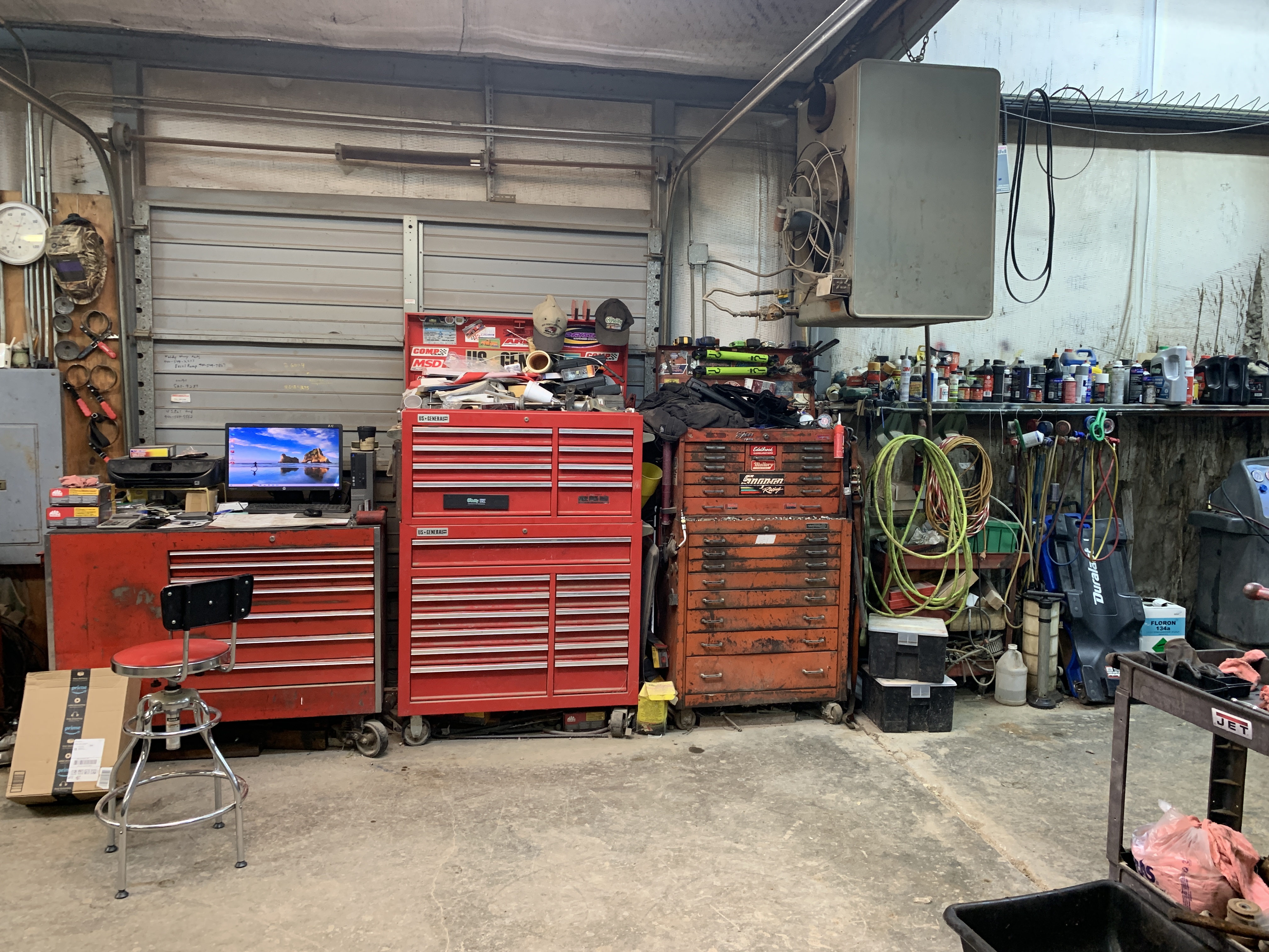 Mechanic inspecting steering and suspension components on a lifted vehicle at Affordable Auto Repair in Graham, TX