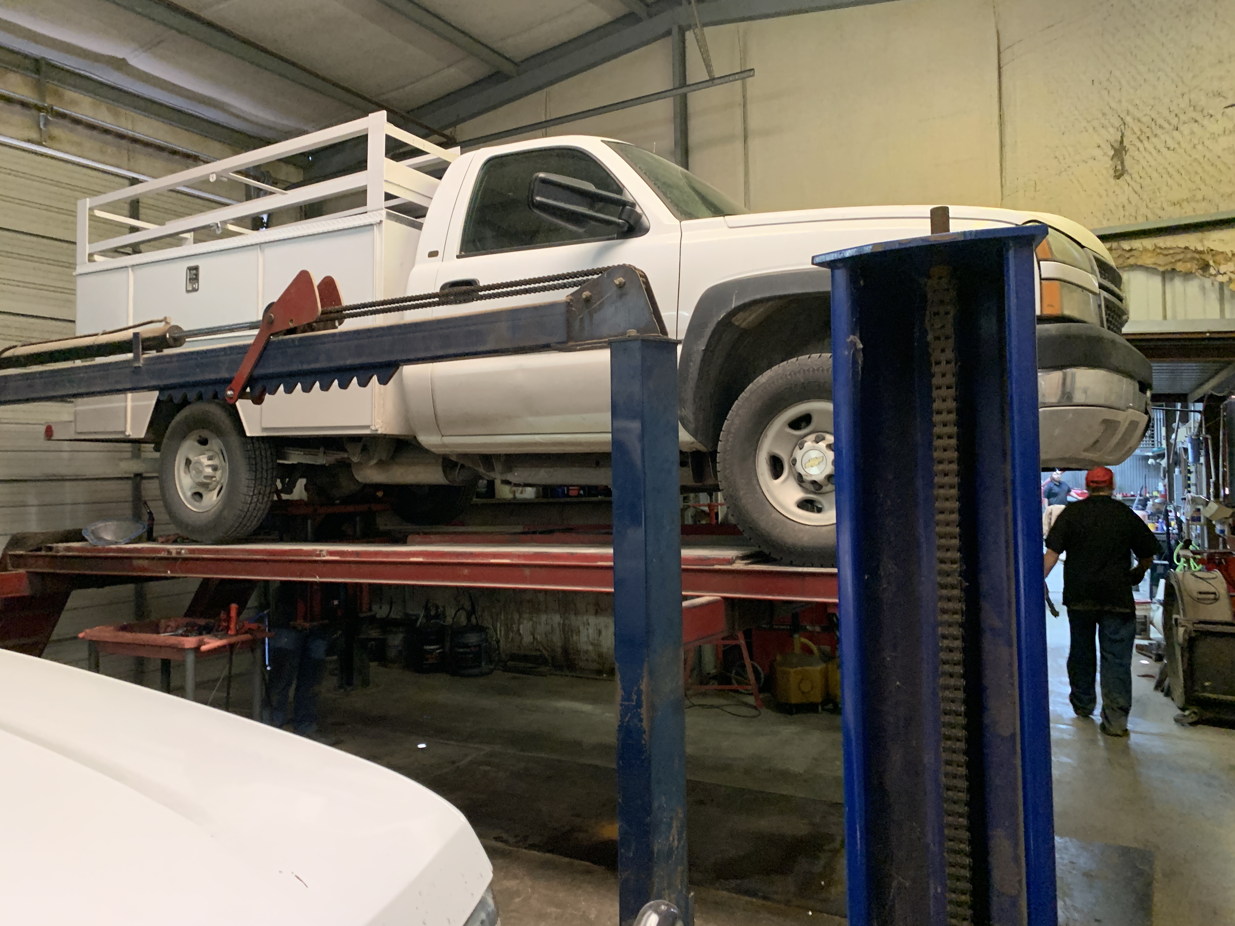 A truck raised on the lift for transmission and undercarriage repair in our Graham, TX shop